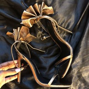 Metallic gold stilettos with heel accent